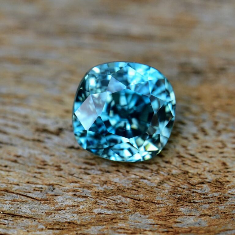 Blue zircon gemstone on a wooden background